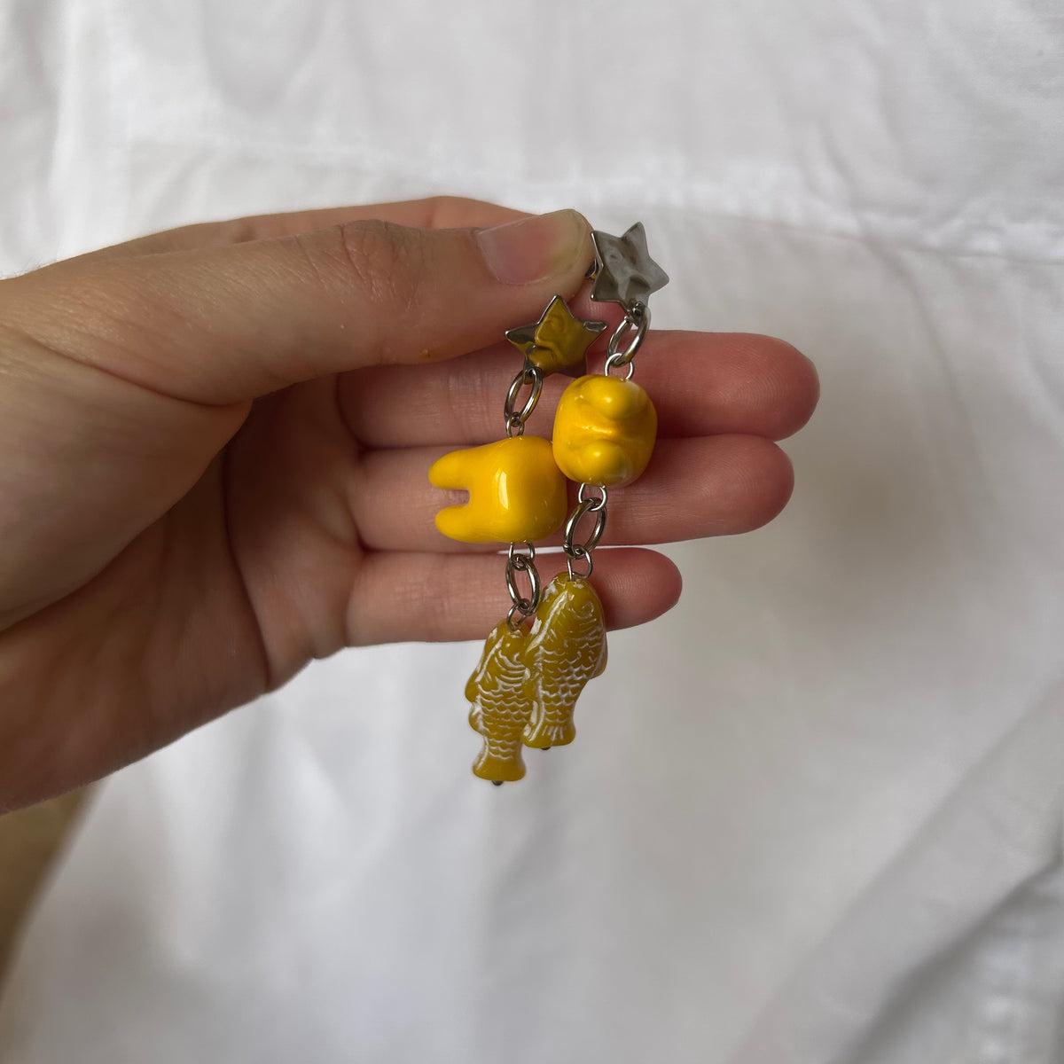 Ceramic tooth yellow fish earrings