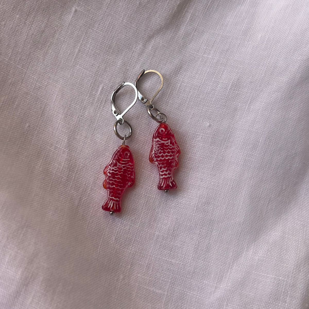 White on red fish earrings